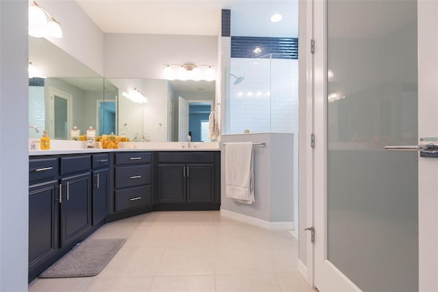 bathroom with vanity, a shower, and tile patterned flooring