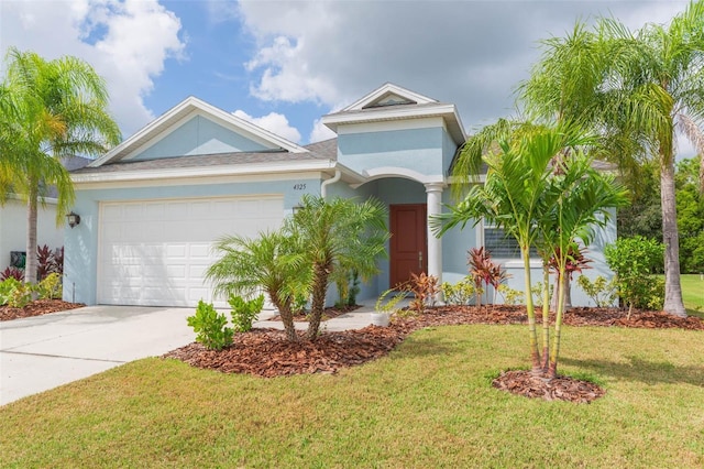 view of front of house with a garage and a front yard