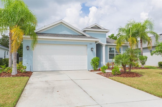 view of front of house featuring a front yard and a garage