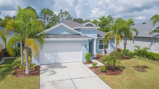 view of front of home with a garage and a front lawn