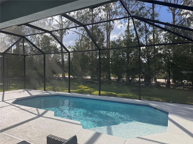 view of pool featuring a patio area and glass enclosure