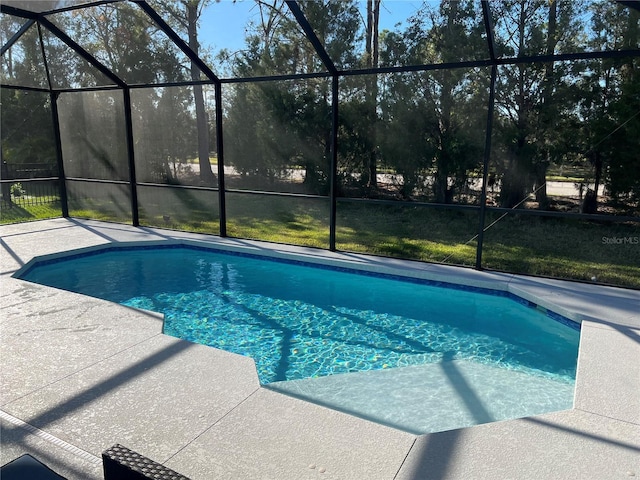 view of swimming pool with a patio and glass enclosure