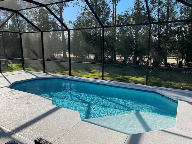 view of swimming pool with a patio and glass enclosure