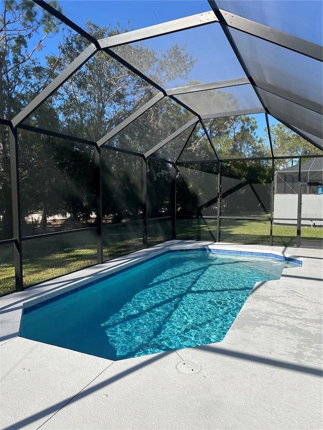 view of pool with glass enclosure