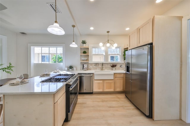 kitchen featuring tasteful backsplash, sink, light hardwood / wood-style floors, stainless steel appliances, and light brown cabinets