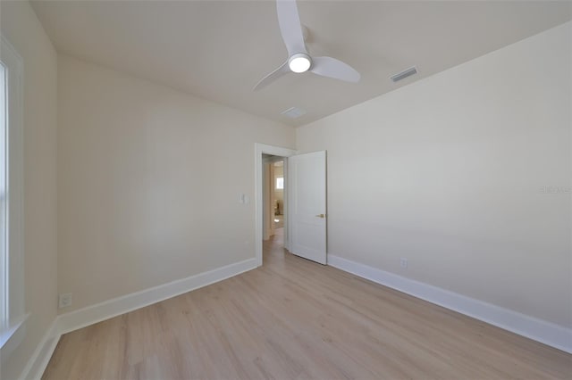 spare room with light wood-type flooring and ceiling fan