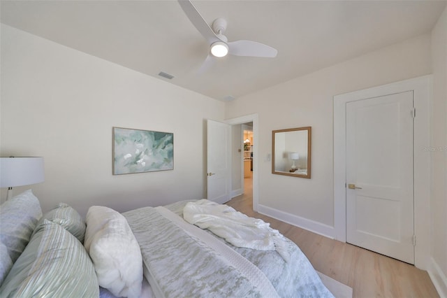 bedroom with light wood-type flooring and ceiling fan