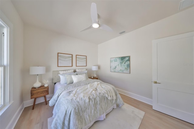 bedroom with light hardwood / wood-style flooring and ceiling fan