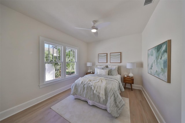 bedroom with light hardwood / wood-style floors and ceiling fan