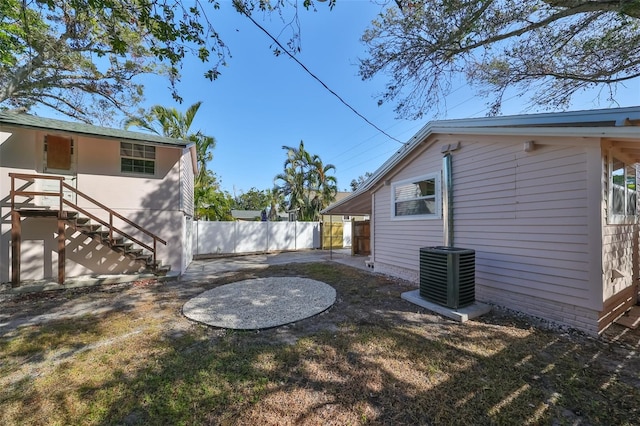 view of yard featuring central air condition unit and a patio area