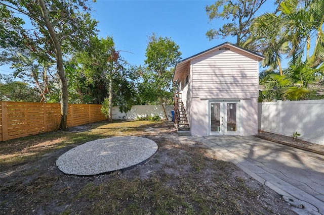 rear view of house featuring a patio and french doors