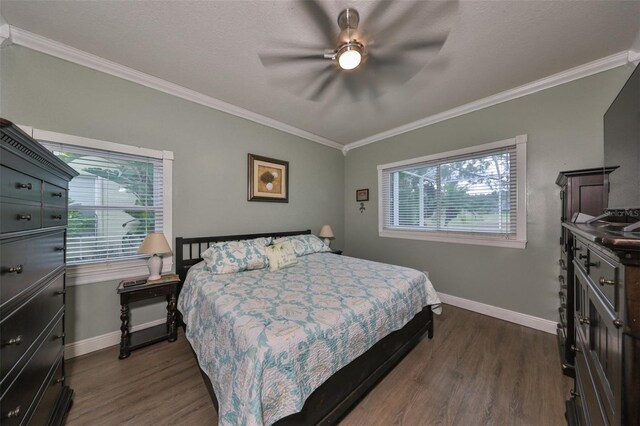 bedroom featuring multiple windows, ceiling fan, and hardwood / wood-style flooring