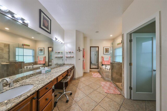 bathroom featuring vanity, tile patterned flooring, and separate shower and tub