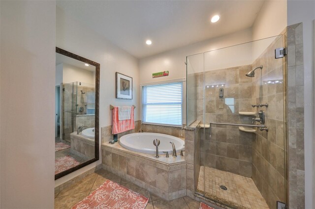 bathroom featuring shower with separate bathtub and tile patterned flooring