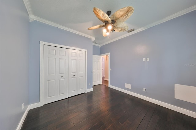 unfurnished bedroom featuring ceiling fan, ornamental molding, a closet, and dark wood-type flooring