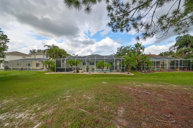 view of yard with glass enclosure and a swimming pool