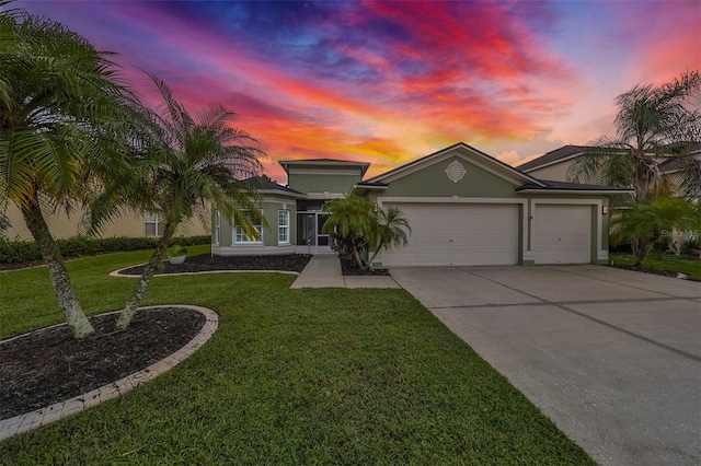 view of front of home with a lawn and a garage