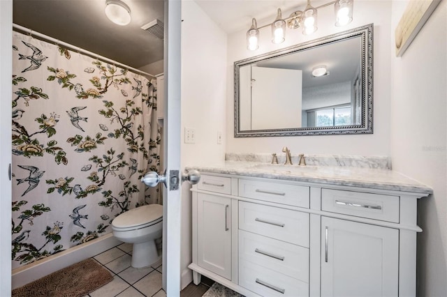 bathroom with walk in shower, vanity, toilet, and tile patterned floors