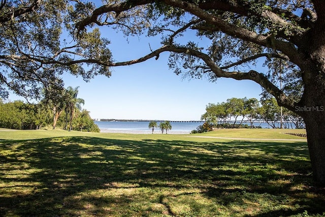 view of home's community featuring a lawn and a water view