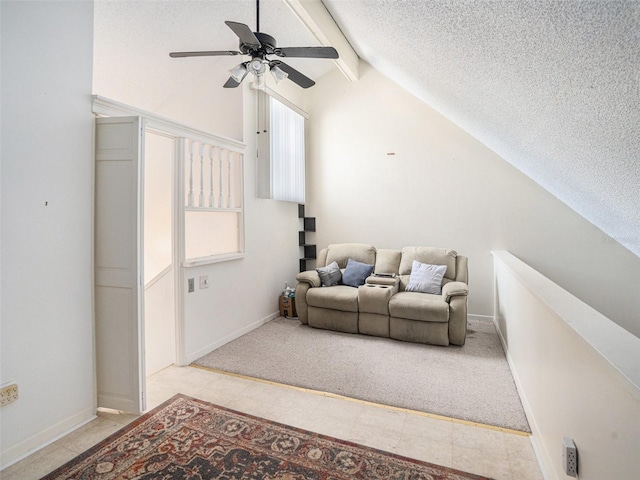 living room featuring ceiling fan, a wealth of natural light, a textured ceiling, and vaulted ceiling with beams