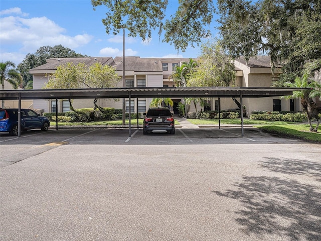 view of parking / parking lot featuring a carport