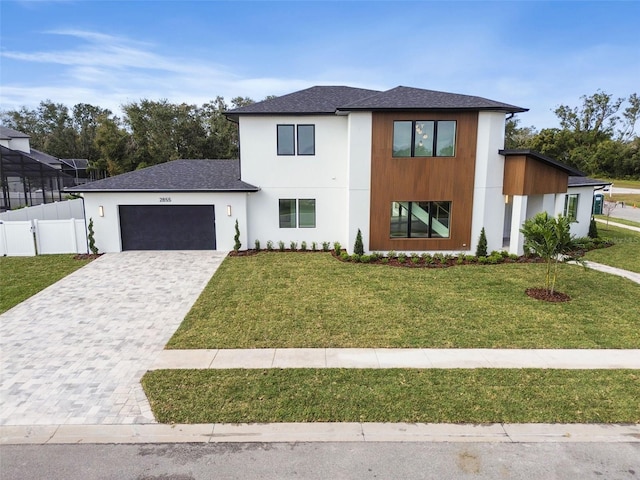 view of front of house featuring a garage and a front yard