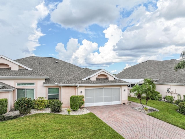 single story home with a front yard and a garage