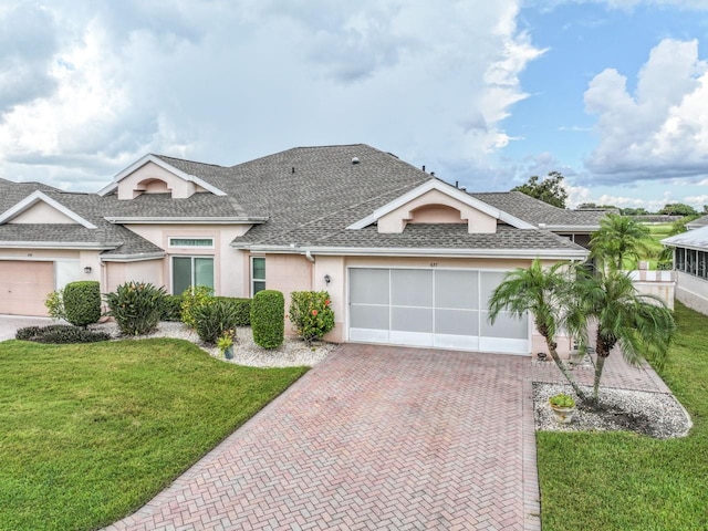 view of front of property with a garage and a front lawn