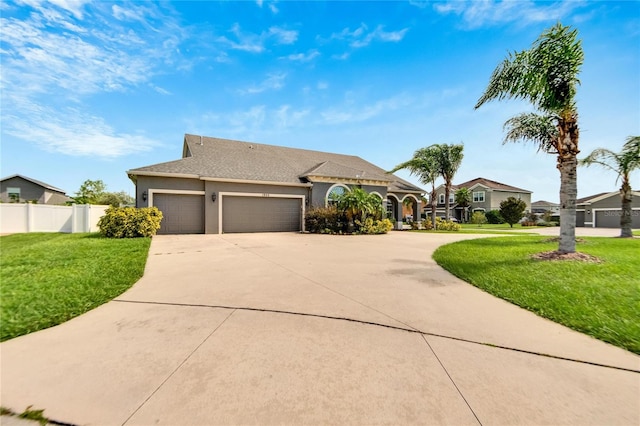 view of front of house featuring a garage and a front lawn