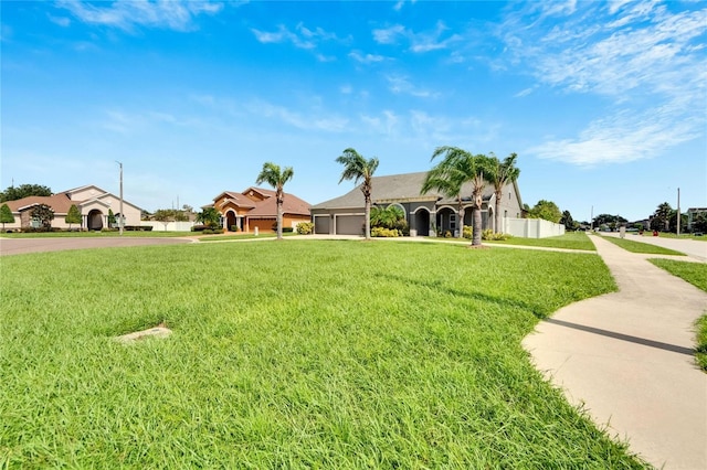 view of front of home with a garage and a front yard