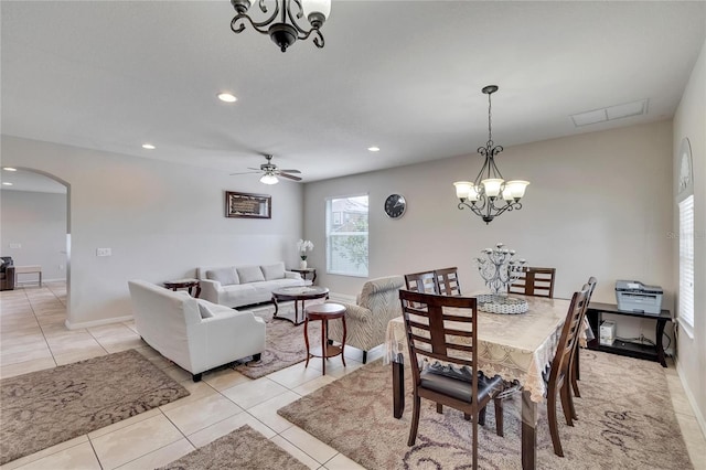 dining room featuring ceiling fan with notable chandelier and light tile patterned floors