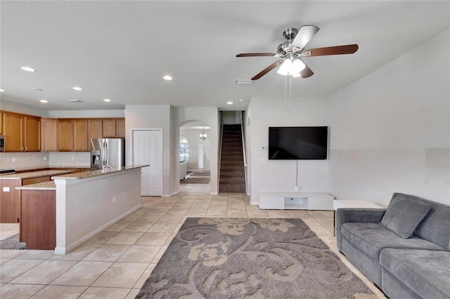 tiled living room featuring ceiling fan