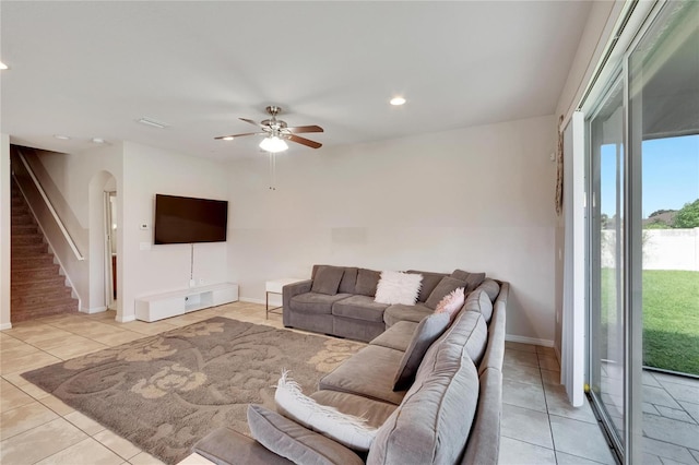 tiled living room featuring ceiling fan