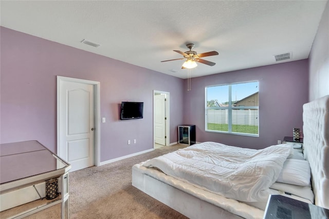 carpeted bedroom with a textured ceiling and ceiling fan