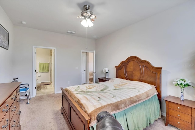 carpeted bedroom with ceiling fan and ensuite bathroom