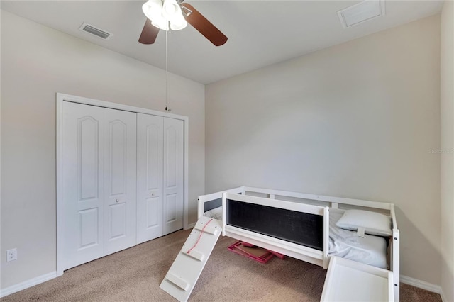 bedroom featuring light carpet, ceiling fan, and a closet