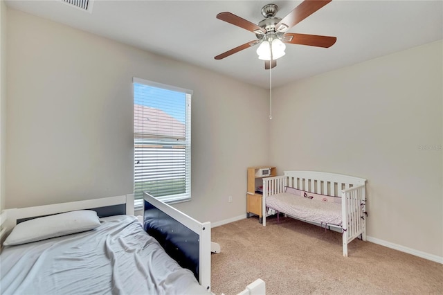 bedroom featuring ceiling fan and light colored carpet