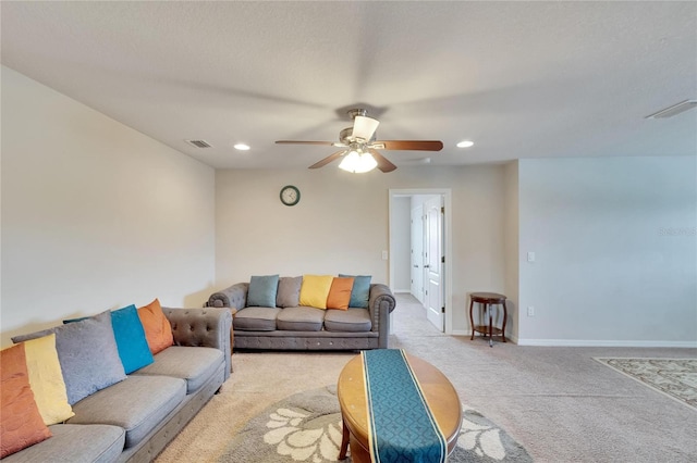 carpeted living room with ceiling fan