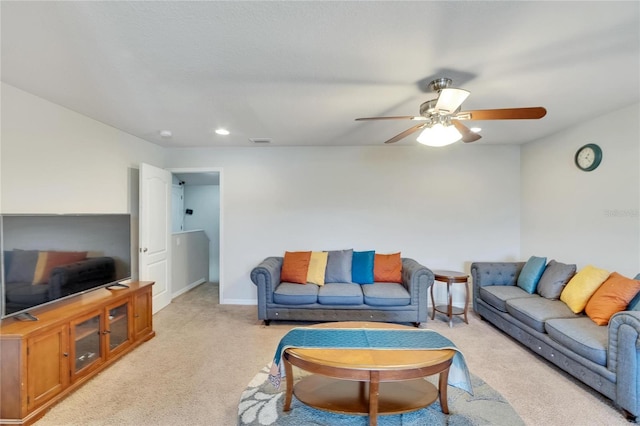 living room with ceiling fan and light colored carpet