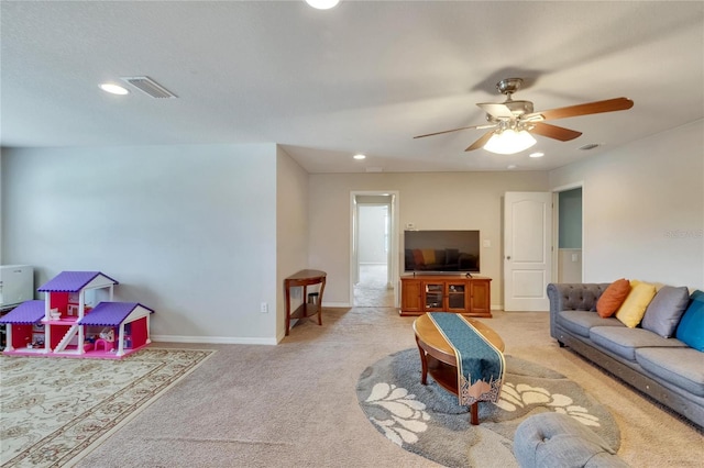 carpeted living room with ceiling fan