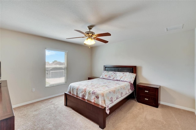 bedroom with ceiling fan and light colored carpet