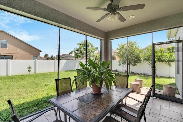 sunroom / solarium featuring ceiling fan