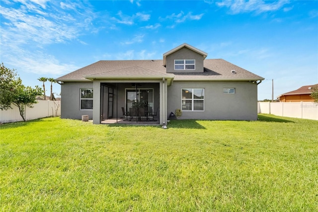 rear view of house with a patio and a yard