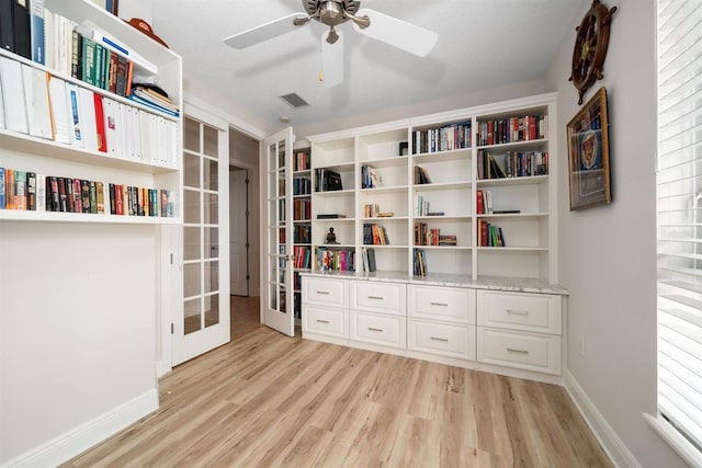 misc room featuring french doors, a textured ceiling, light wood-type flooring, and ceiling fan