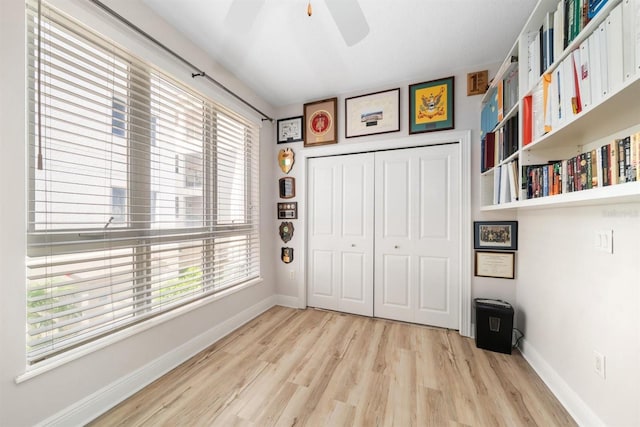 1030 Bellasol Way Unit 201, Apollo Beach, FL 33572 - bedroom with light wood-type flooring, baseboards, a closet, and ceiling fan