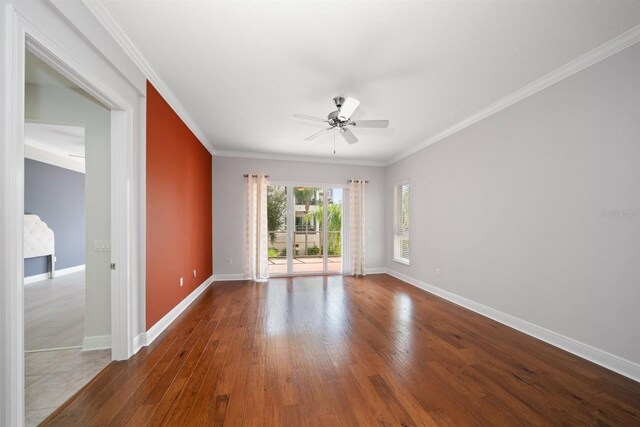 1030 Bellasol Way Unit 201, Apollo Beach, FL 33572 - spare room featuring ceiling fan, wood finished floors, baseboards, and crown molding