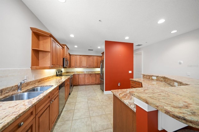 1030 Bellasol Way Unit 201, Apollo Beach, FL 33572 - kitchen with appliances with stainless steel finishes, a sink, open shelves, brown cabinets, and light stone counters