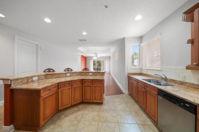 1030 Bellasol Way Unit 201, Apollo Beach, FL 33572 - kitchen featuring dishwasher, a sink, light stone countertops, recessed lighting, and a textured ceiling