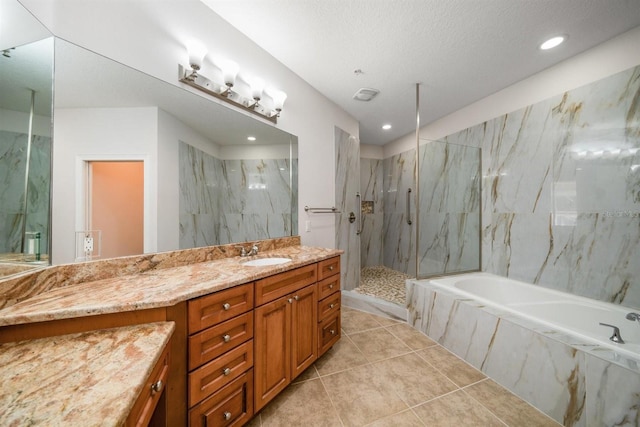 bathroom with vanity, tile patterned floors, independent shower and bath, and a textured ceiling