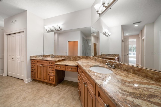 1030 Bellasol Way Unit 201, Apollo Beach, FL 33572 - full bath featuring tile patterned flooring, two vanities, walk in shower, and baseboards